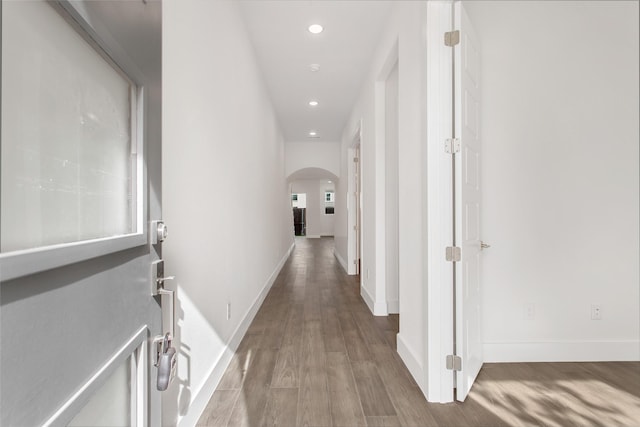 hallway with hardwood / wood-style floors