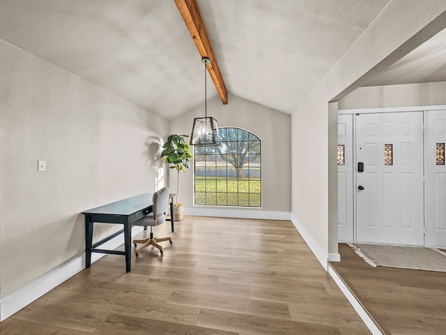 entrance foyer with wood-type flooring and lofted ceiling with beams