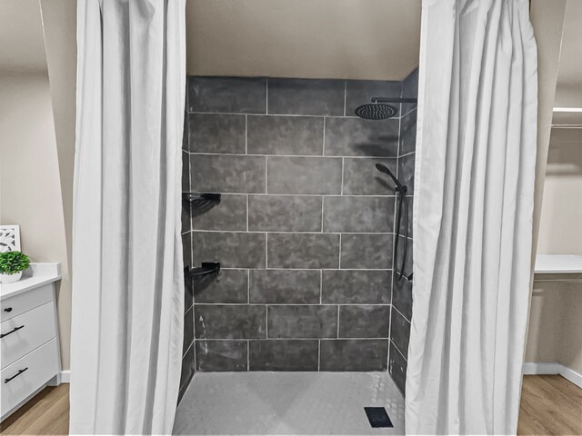 bathroom with hardwood / wood-style flooring and a shower with curtain