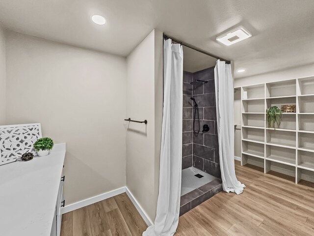 bathroom featuring a shower with shower curtain and hardwood / wood-style floors