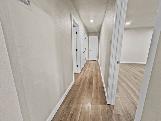 hallway with light hardwood / wood-style flooring