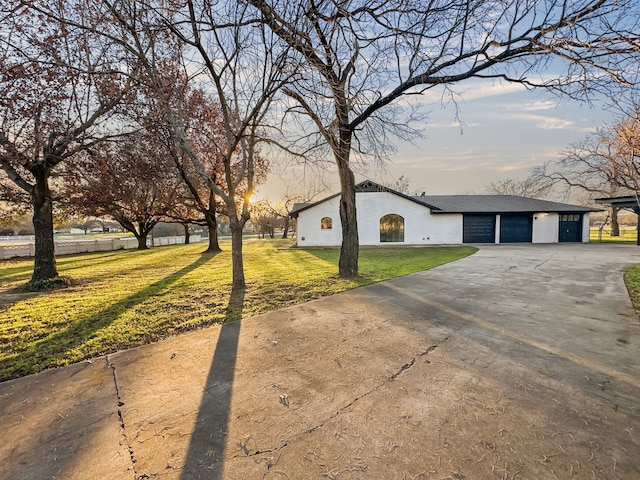 view of front of home with a yard and a garage