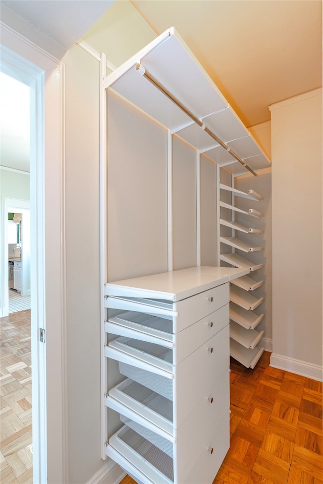 walk in closet featuring parquet flooring