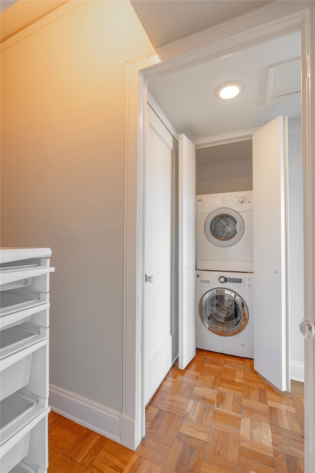 washroom featuring light parquet floors and stacked washer and clothes dryer