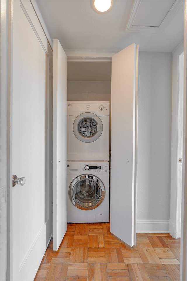 laundry room with stacked washer and clothes dryer and light parquet flooring