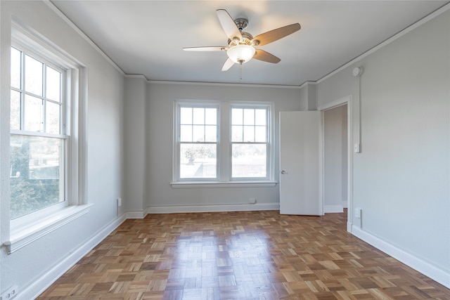 unfurnished room with crown molding, parquet flooring, plenty of natural light, and ceiling fan