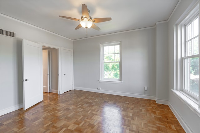 spare room featuring ceiling fan, ornamental molding, and light parquet floors