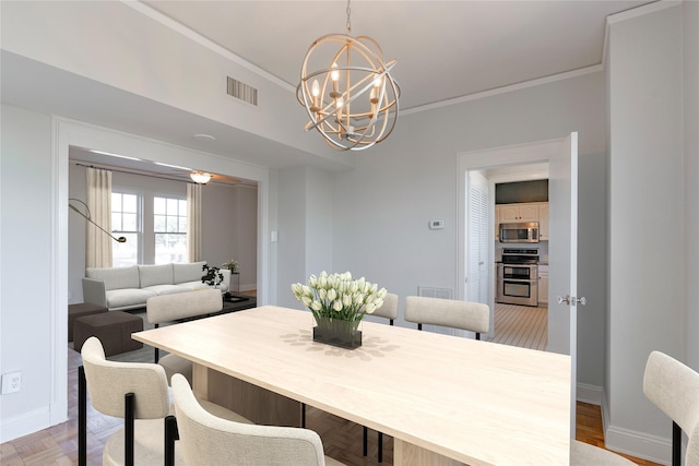 dining area with a notable chandelier, visible vents, crown molding, and baseboards