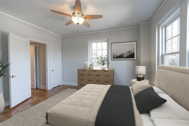 bedroom with baseboards, a ceiling fan, and crown molding