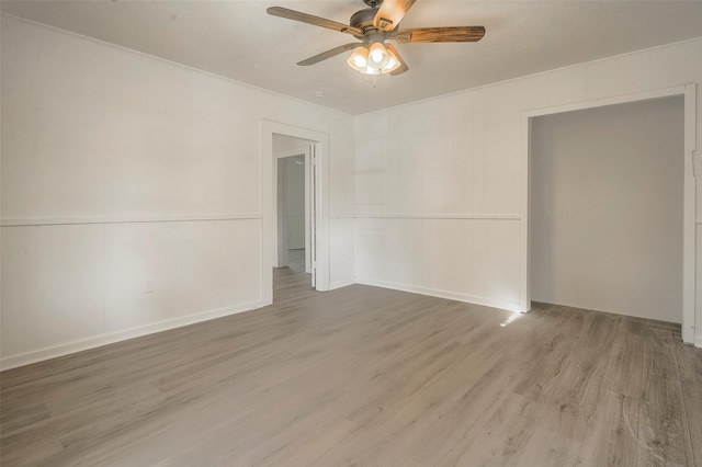 spare room with hardwood / wood-style floors and ceiling fan