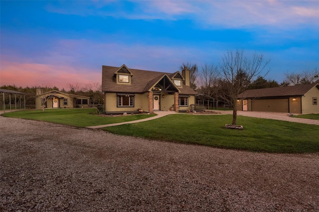 view of front of property with a lawn, a garage, and an outdoor structure