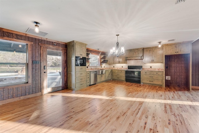 kitchen featuring decorative light fixtures, black microwave, range with electric stovetop, dishwasher, and green cabinets