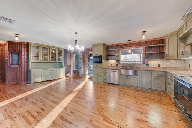 kitchen featuring hanging light fixtures, electric range, stainless steel dishwasher, and black microwave