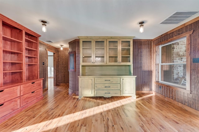 interior space featuring wooden walls and light wood-type flooring