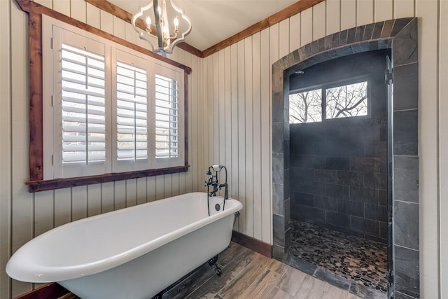 bathroom with hardwood / wood-style flooring, shower with separate bathtub, and an inviting chandelier