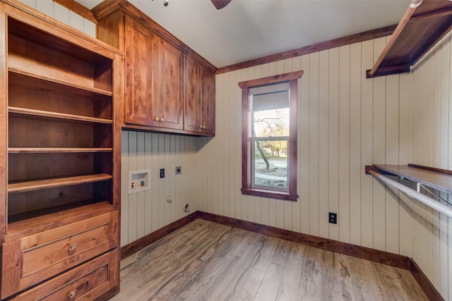 laundry room featuring electric dryer hookup, cabinets, washer hookup, light hardwood / wood-style floors, and hookup for a gas dryer