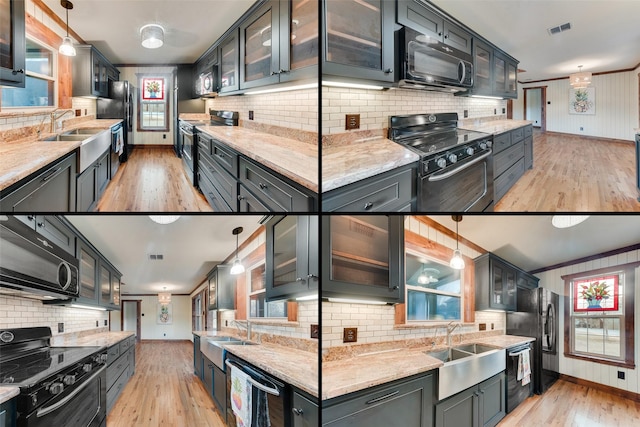 kitchen with sink, pendant lighting, light stone counters, and black appliances