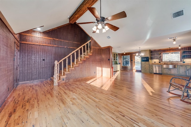 unfurnished living room with beamed ceiling, ceiling fan, sink, and hardwood / wood-style floors