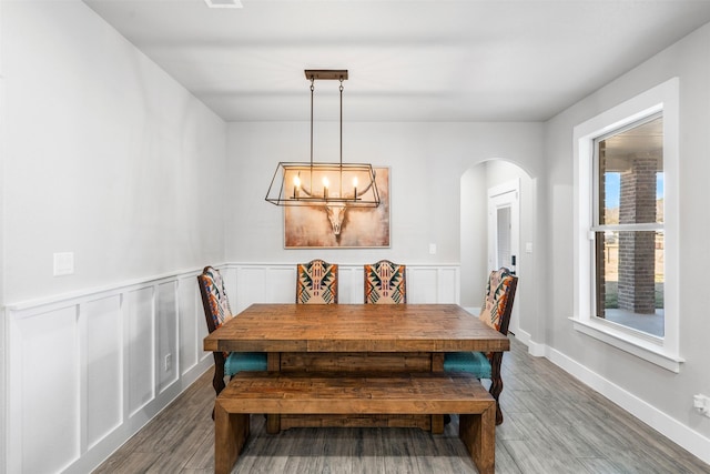 dining room featuring hardwood / wood-style flooring and an inviting chandelier