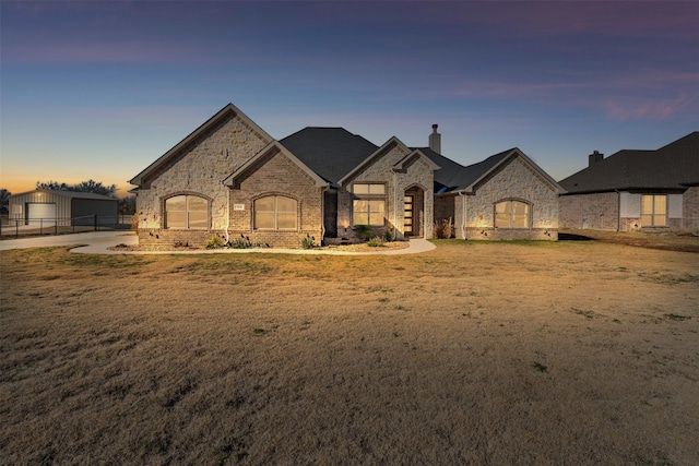 french country style house featuring a yard