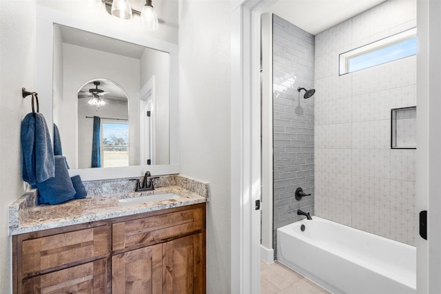 bathroom featuring tiled shower / bath, tile patterned floors, ceiling fan, and a healthy amount of sunlight