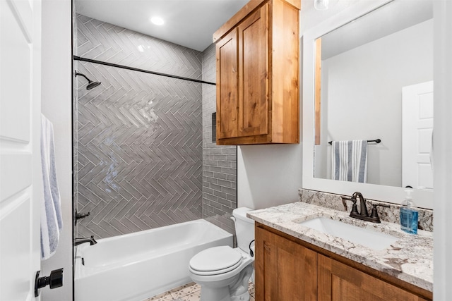 full bathroom with vanity, tiled shower / bath combo, and toilet