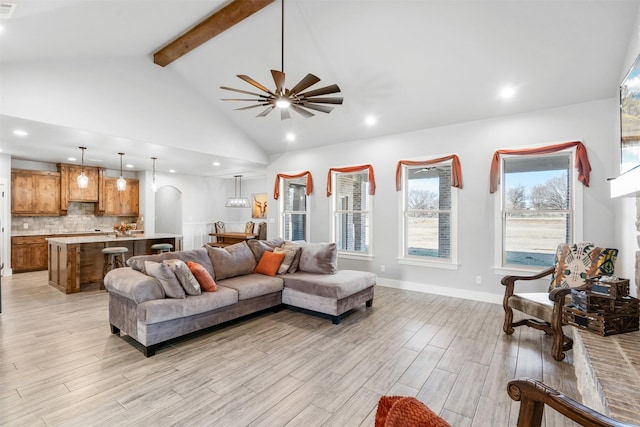 living room with beam ceiling, ceiling fan, and high vaulted ceiling