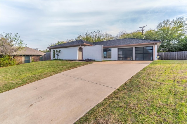 ranch-style house with a front yard and a garage