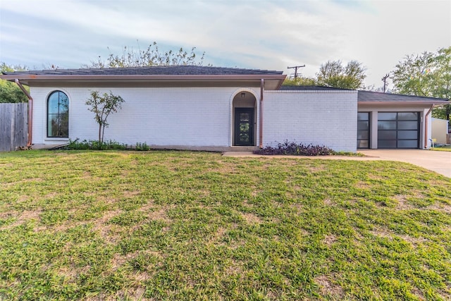 view of front facade with a front lawn and a garage