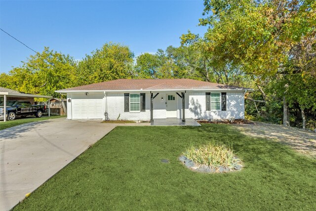 ranch-style home featuring covered porch, a garage, and a front yard