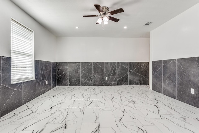 bathroom with ceiling fan and a healthy amount of sunlight