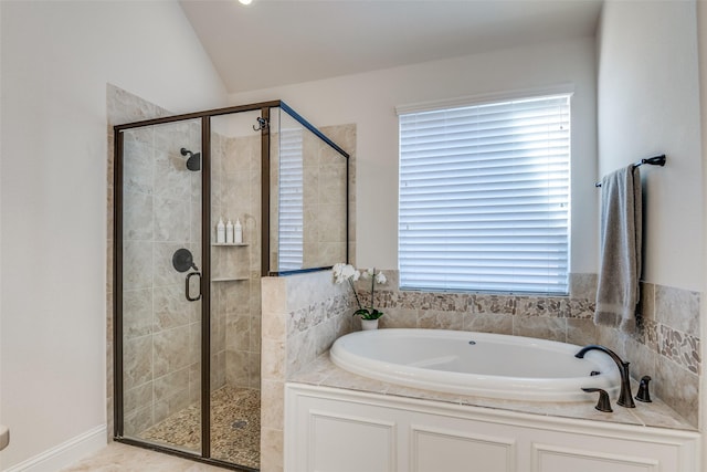 bathroom with lofted ceiling and plus walk in shower