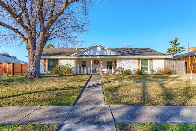 ranch-style home featuring a porch and a front lawn