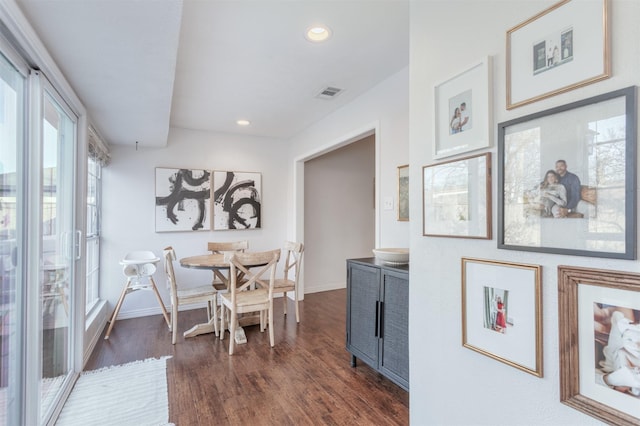 dining area with dark hardwood / wood-style floors