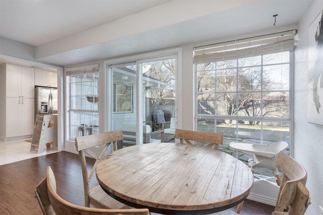 dining area featuring light hardwood / wood-style flooring and a healthy amount of sunlight