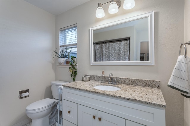 bathroom featuring vanity and toilet