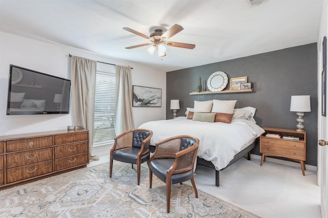 bedroom with ceiling fan and light carpet