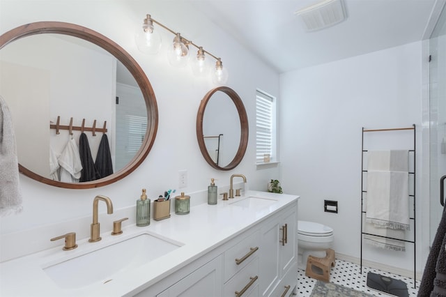 bathroom featuring vanity, toilet, and walk in shower