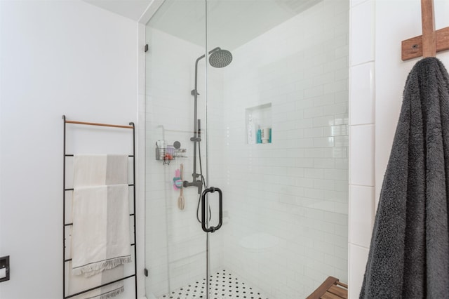 bathroom with a shower with shower door