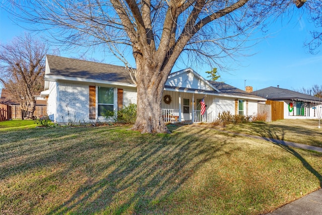 ranch-style home featuring a porch and a front yard