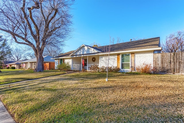 single story home with covered porch and a front yard