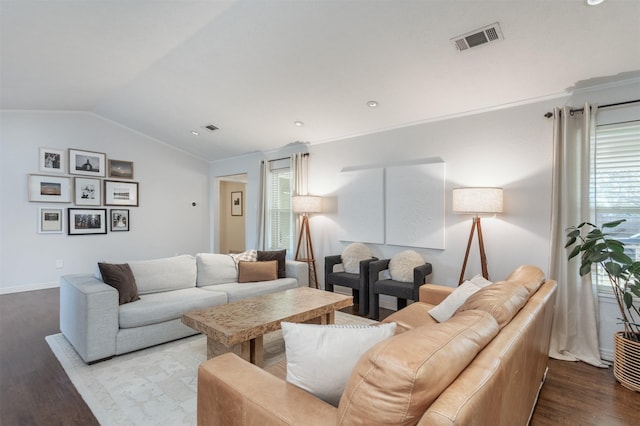 living room with crown molding, lofted ceiling, and hardwood / wood-style flooring