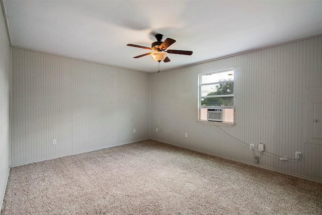 carpeted spare room with ceiling fan and ornamental molding