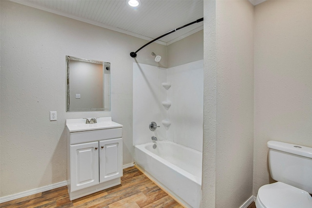 full bathroom featuring toilet, wood-type flooring, ornamental molding, and vanity