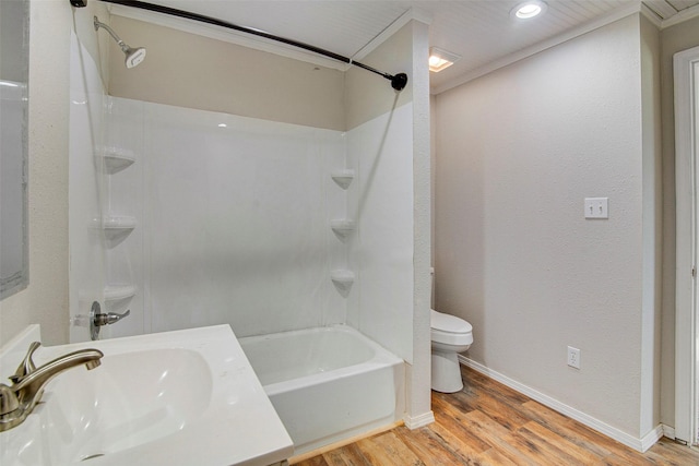 full bathroom with sink, tub / shower combination, hardwood / wood-style floors, toilet, and ornamental molding