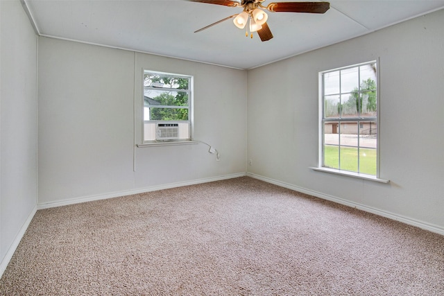 carpeted spare room with plenty of natural light, cooling unit, and ceiling fan