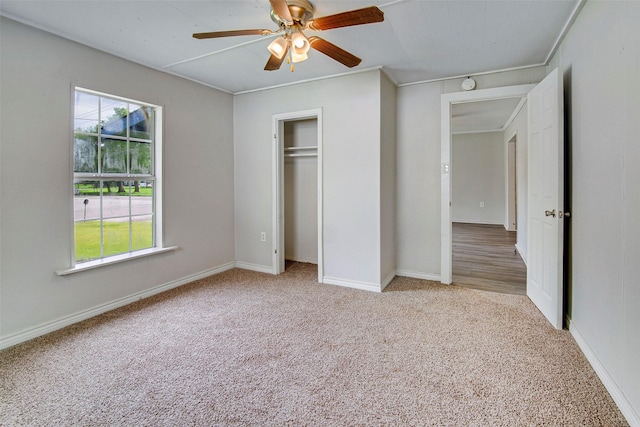 unfurnished bedroom featuring light carpet, ceiling fan, and ornamental molding