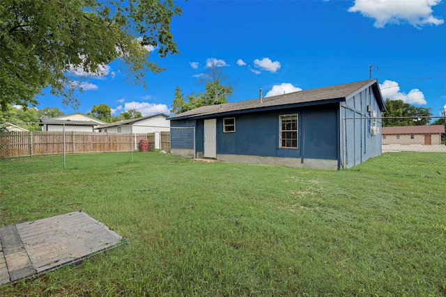 back of house with a lawn