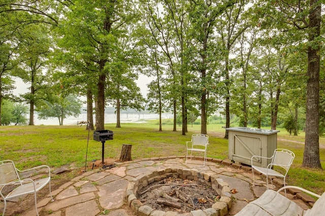 view of patio / terrace with a water view and a fire pit