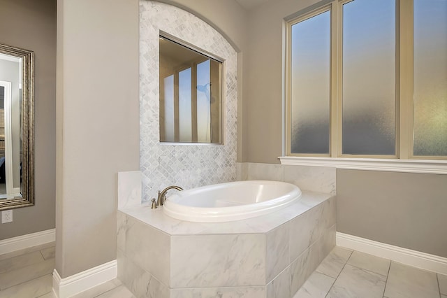 bathroom with tiled tub